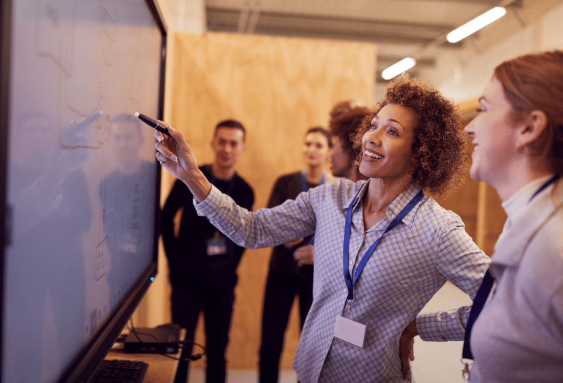 An experienced mentor guiding an apprentice in an engineering workshop, symbolising the impact of apprenticeship and functional skills reform on hands-on learning and workforce development.