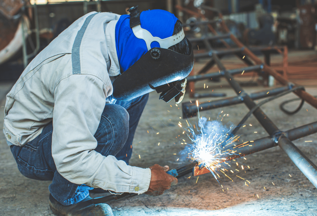 A metal fabrication apprentice welding steel in a workshop, showcasing the hands-on skills and technical training involved in a level 3 Metal Fabrication Apprenticeship.