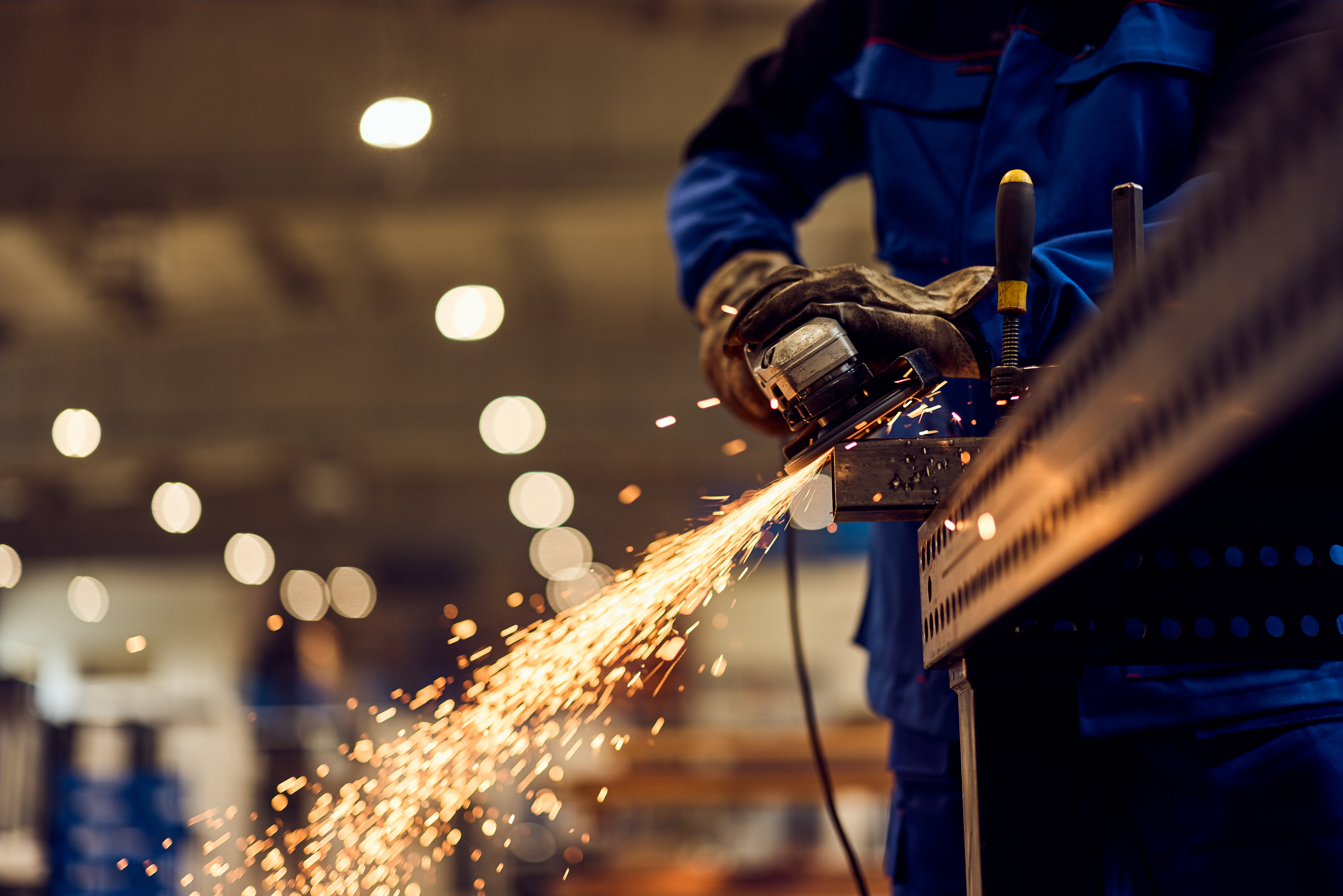 Metal Fabrication Apprenticeship training with a worker cutting and shaping steel using industrial equipment.